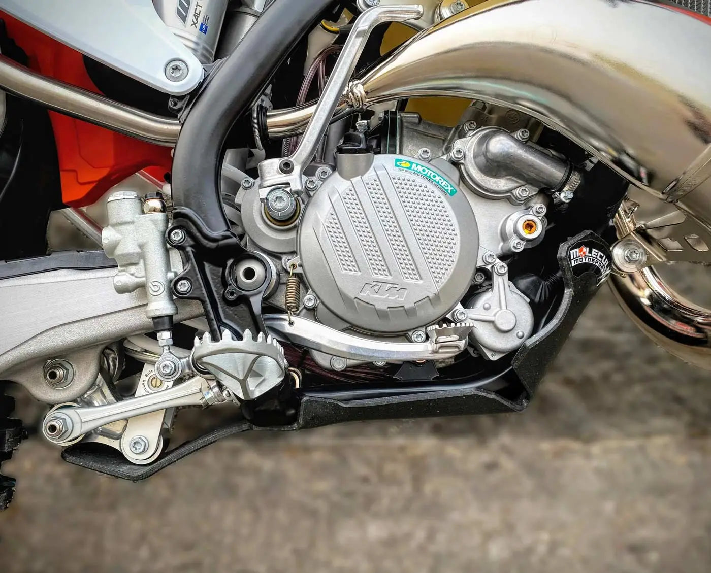 Close-up of a motorcycle engine with KTM branding on a blurred background