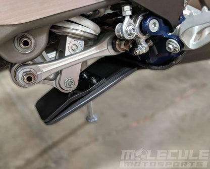 Linkage guard on Molecule Motorsports Skid Plate