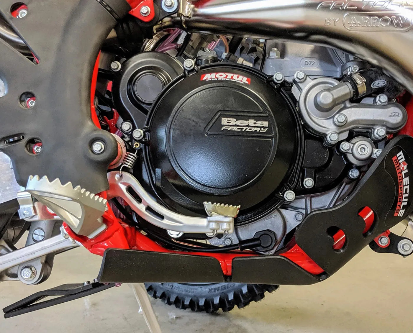 Close-up of a motorcycle engine with 'Beta Factory' branding.