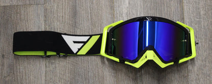 Pair of goggles with a black and green frame on a wooden surface