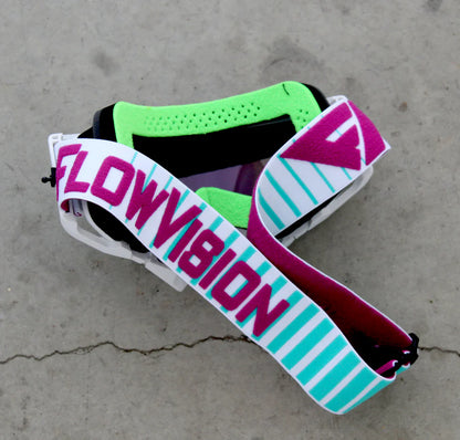 Goggles with colorful straps on a concrete surface