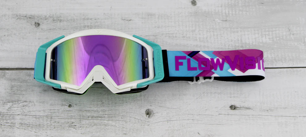 Colorful goggles with a 'Flow' logo on a wooden surface