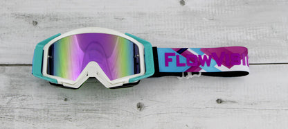 Colorful goggles with a 'Flow' logo on a wooden surface
