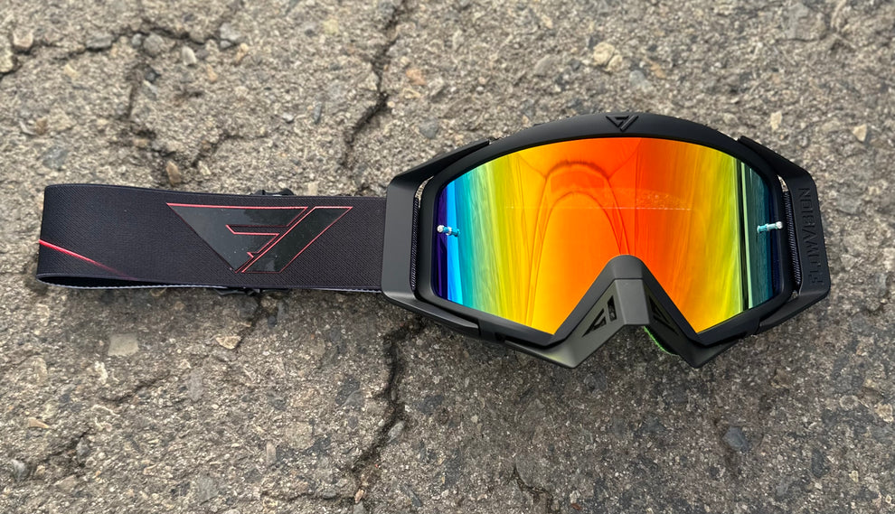 FlowVision Company Neon goggles with a black strap on a textured surface