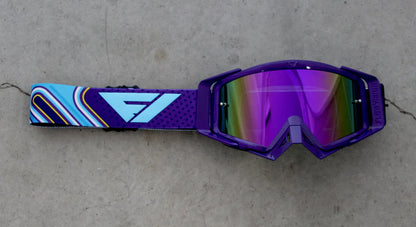 Flowvision Pipeline goggles with a colorful strap on a gray surface