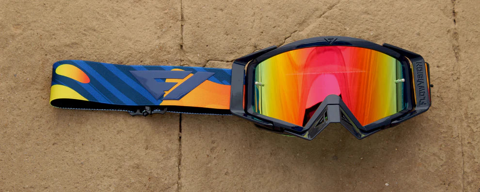 Colorful goggles with a reflective lens on a brown surface