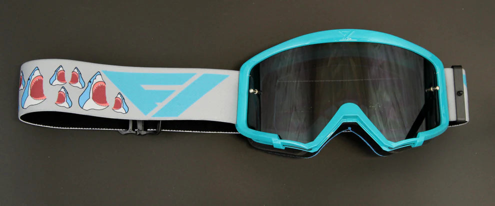 Motocross goggles with shark design strap on a dark background