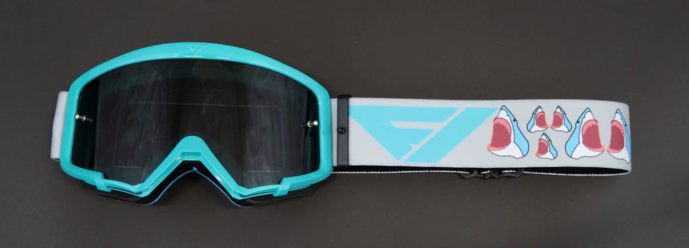Teal goggles with a colorful strap on a dark background
