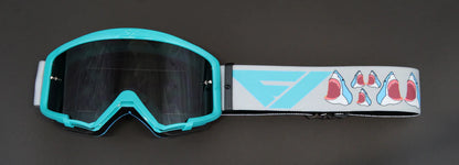 Teal goggles with a colorful strap on a dark background